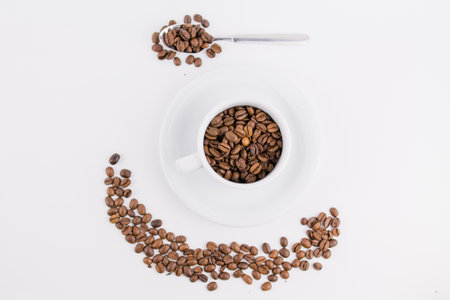 a coffee cup with coffee beans on white backgroundの写真素材