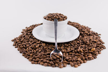a coffee cup with coffee beans on white backgroundの写真素材