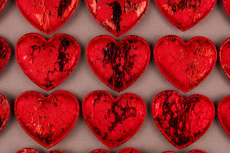 a background of red hearts on the background for the holiday of love Valentine's day February 14の写真素材