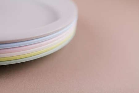 a set of plastic reusable colorful plates on the kitchen tableの写真素材