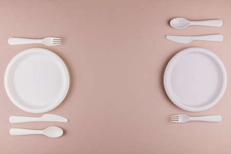 a table setting in a restaurant for two persons with a plate spoon fork knifeの写真素材