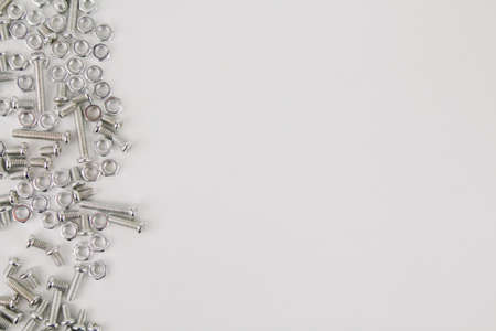 a iron screws and nuts on a white background for repair and constructionの写真素材
