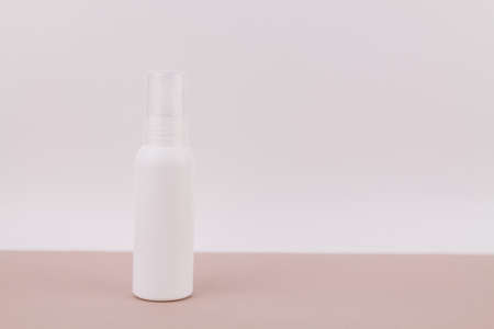 a white bottle without an inscription on a light background for perfume or antiseptic gelの写真素材