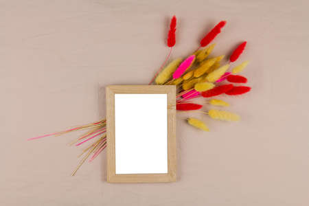 a photo frame with a decor of dried flowers on the background