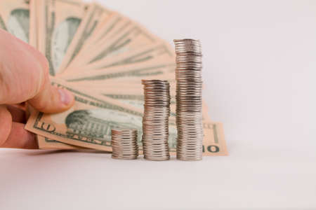 a money coins in columns with dollar bills on a white backgroundの写真素材