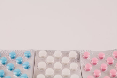 a ablets of different colors in blisters on the background of medicinesの写真素材