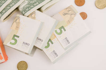 euro paper money with coins on white backgroundの写真素材