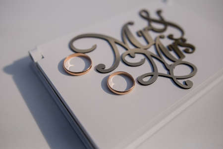 a mr and mrs lettering with wedding rings