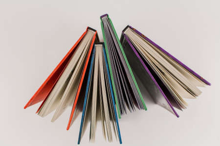 a new books of different colors on white background