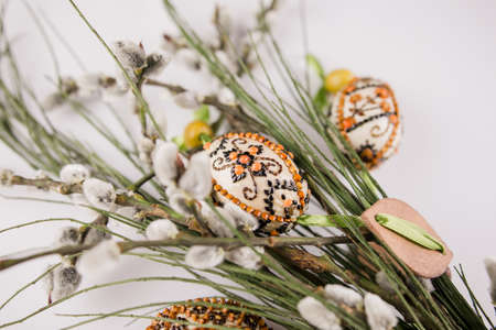 Easter eggs with a sprig on white backgroundの写真素材