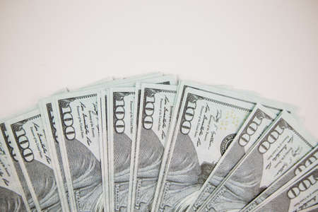 lot of one hundred dollar bills on a white background for businessの写真素材