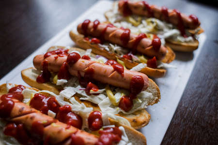 a hot dogs with sauce on the table in the kitchenの写真素材