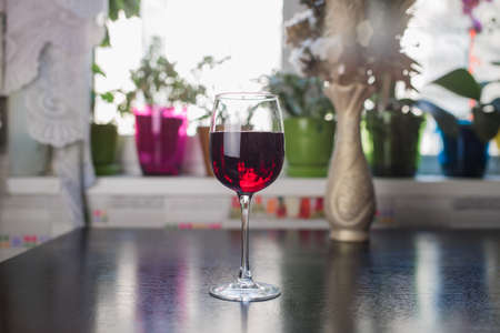 glass of red wine on the kitchen tableの写真素材
