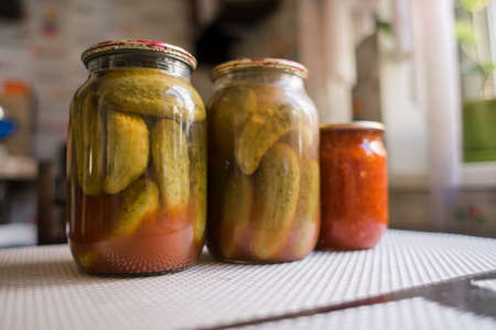 a canned cucumbers in a jar on the kitchen tableの写真素材