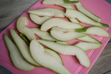 a chopped ripe pear on the kitchen tableの写真素材