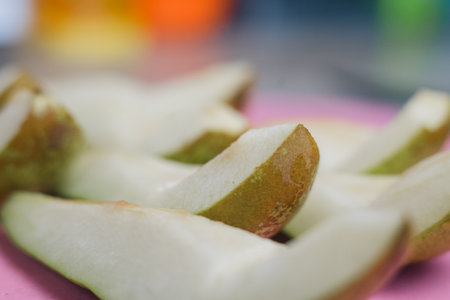 a chopped ripe pear on the kitchen tableの写真素材