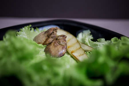 a pear with chicken liver in a salad in the kitchenの写真素材