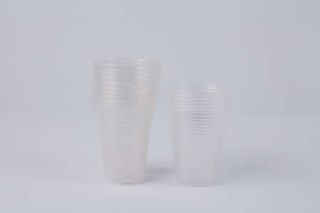 a transparent plastic glasses on white background ecology