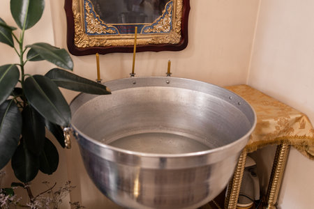 a christening bowl in the church with candles