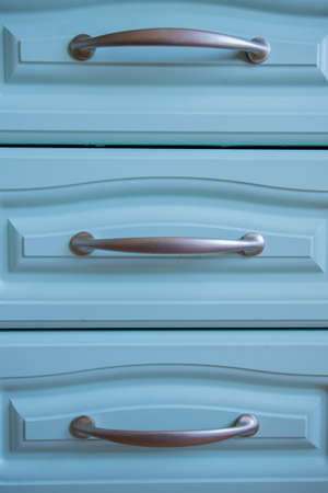 a metal shelf handles in a blue kitchenの写真素材