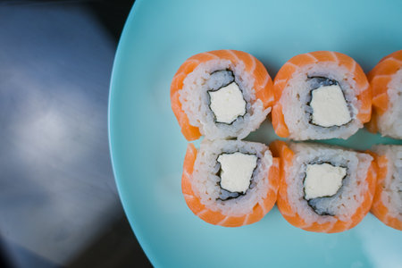 a roll with salmon and white rice and cream cheeseの写真素材