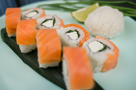 a roll with salmon and white rice and cream cheeseの写真素材