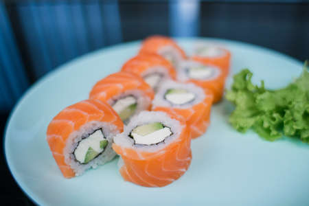 a roll with salmon and white rice and cream cheeseの写真素材