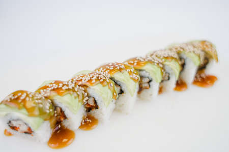 a Japanese cuisine roll with avocado and sesame seedsの写真素材