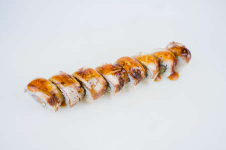 a sushi roll with eel and unagi sauce on a plate japanese cuisineの写真素材