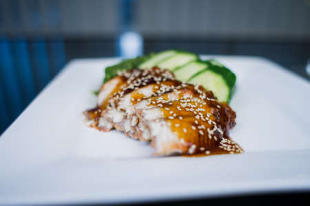 an eel pieces in unagi sauce with cucumber japanese cuisine deliveryの写真素材