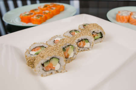 a Philadelphia roll with salmon in sesame and white riceの写真素材