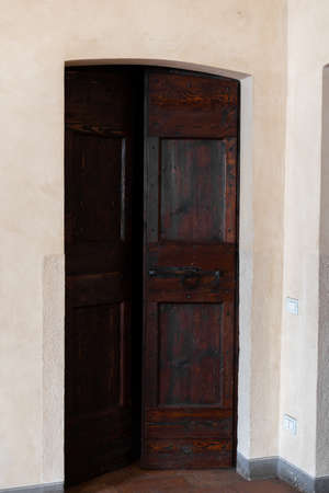 an old wooden door in european historical architecture buildingの写真素材