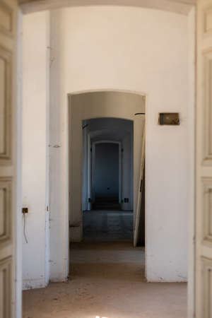 a long corridor with arches in an old house in europeの写真素材