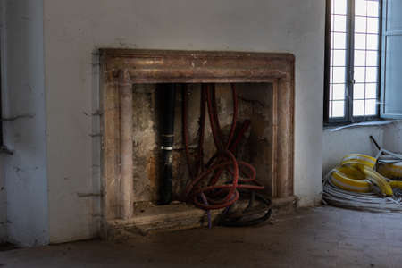 an old vintage beautiful fireplace in an old houseの写真素材