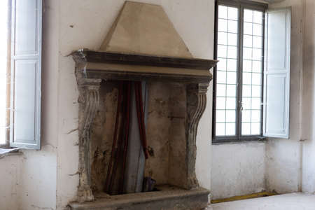 an old vintage beautiful fireplace in an old houseの写真素材