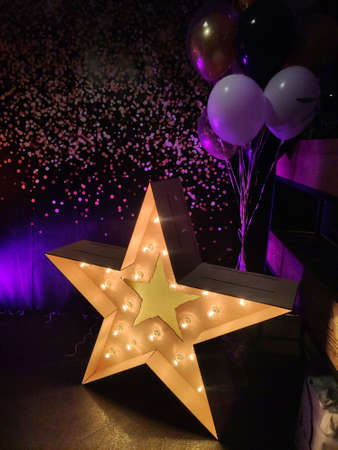a wooden star with light bulbs at the partyの写真素材