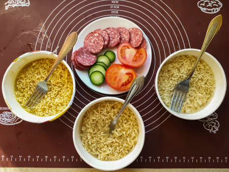 an instant noodles with sausage and vegetables fast foodの写真素材