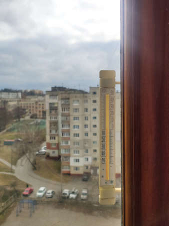 thermometer on the window in a city with high-rise buildingsの写真素材