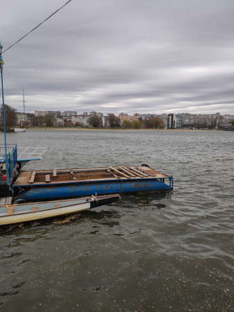 an old kayak near the pier on the riverの写真素材