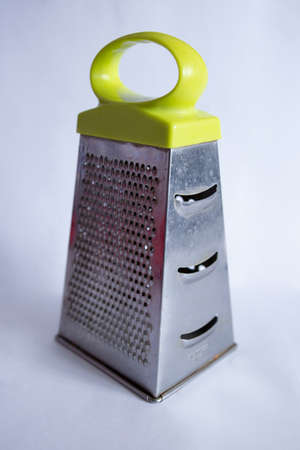 an old metal grater on a white backgroundの写真素材