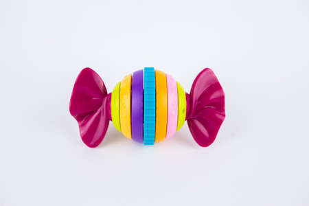 a children's plastic toy in the shape of a candy on a white backgroundの写真素材