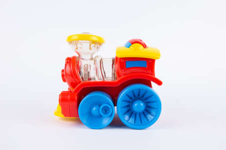 a children's plastic toy steam locomotive on a white backgroundの写真素材