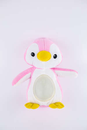 a pink penguin children's soft toy on a white backgroundの写真素材