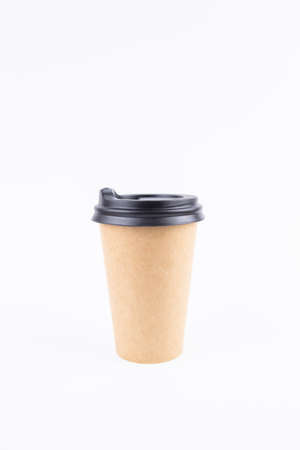 paper cup for coffee with a lid and a straw on a white backgroundの写真素材