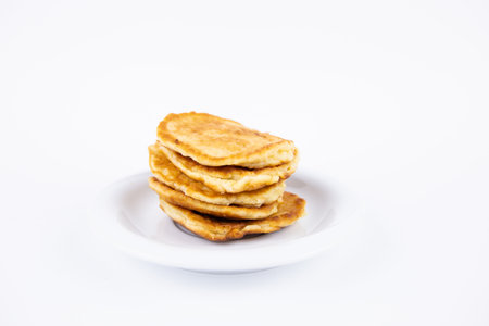 a lush tasty fritters on a plate on a white backgroundの写真素材