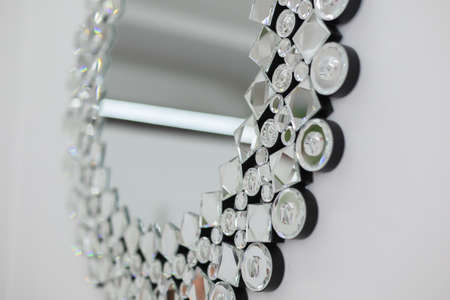 a beautiful decorative mirror in crystals in the room on the wallの写真素材