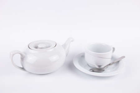white a porcelain teapot and cup on saucer for coffee or tea emptyの写真素材