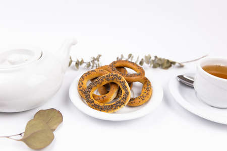 a white porcelain cup with tea for tomorrow on the table with a saucer