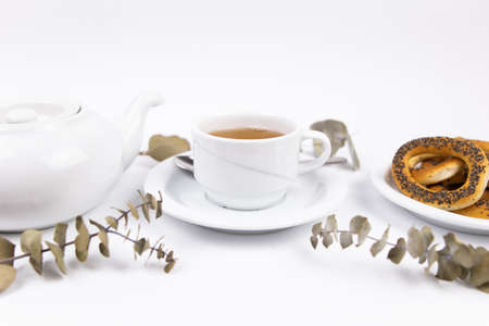 a white porcelain cup with tea for tomorrow on the table with a saucerの写真素材