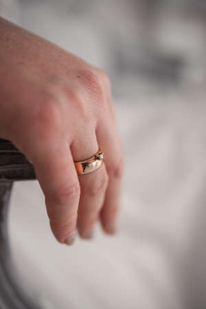 a woman's hand on a chair with a golden ring at the brideの写真素材